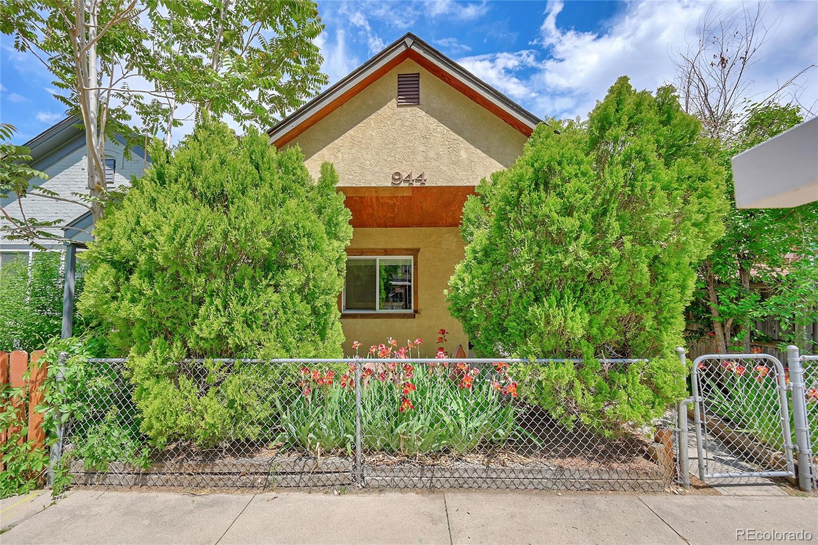 944 Inca Street Denver, CO 80204 - Photo 1 of 29 a front view of a house with garden