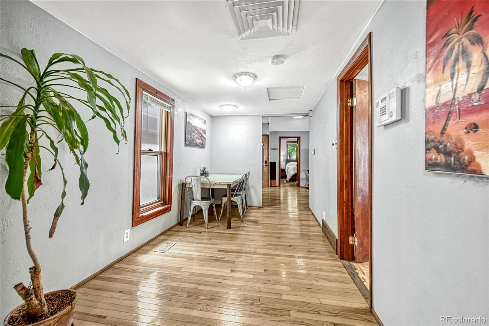 944 Inca Street Denver, CO 80204 - Photo 12 of 29 a view of a hallway with furniture and a potted plant