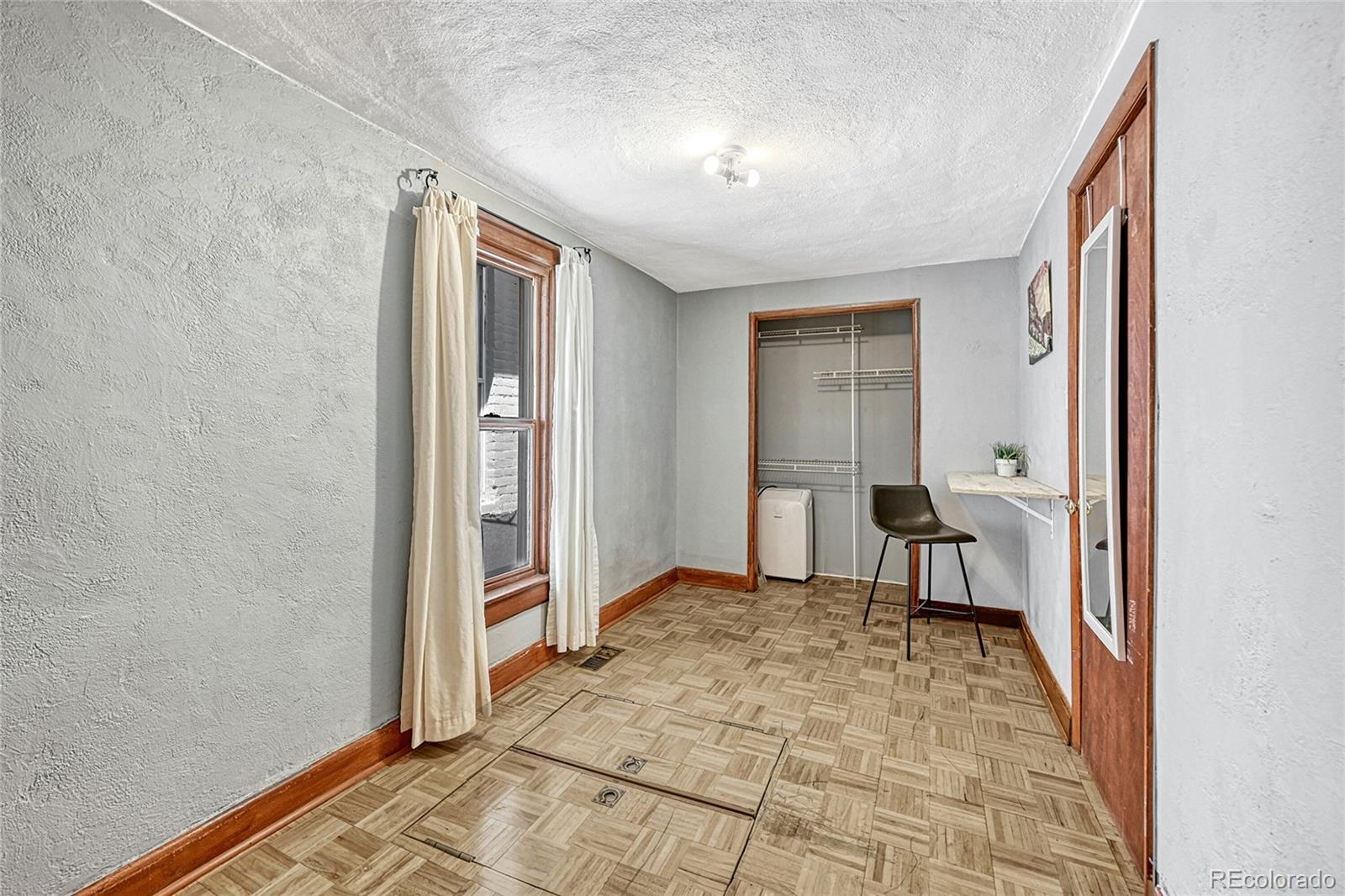 944 Inca Street Denver, CO 80204 - Photo 13 of 29 a view of a hallway with furniture and a window