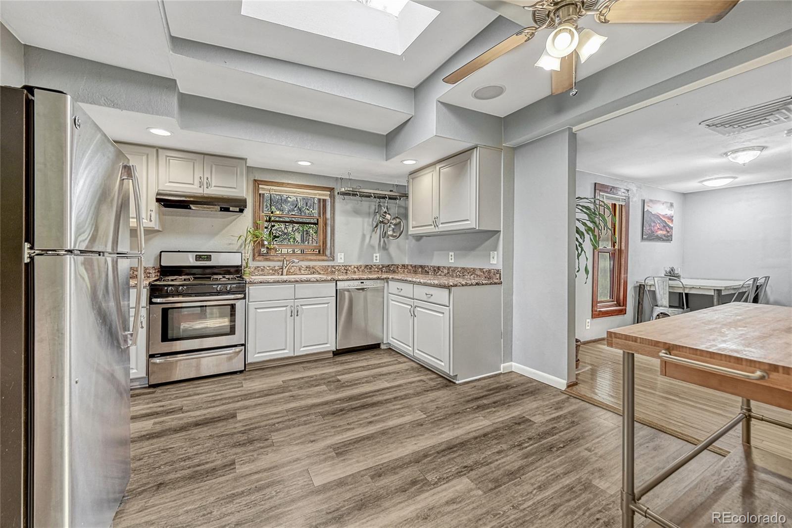 944 Inca Street Denver, CO 80204 - Photo 15 of 29 a kitchen with a refrigerator and a stove top oven