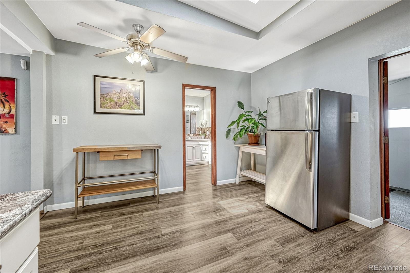 944 Inca Street Denver, CO 80204 - Photo 17 of 29 a view of a refrigerator in kitchen and wooden floor