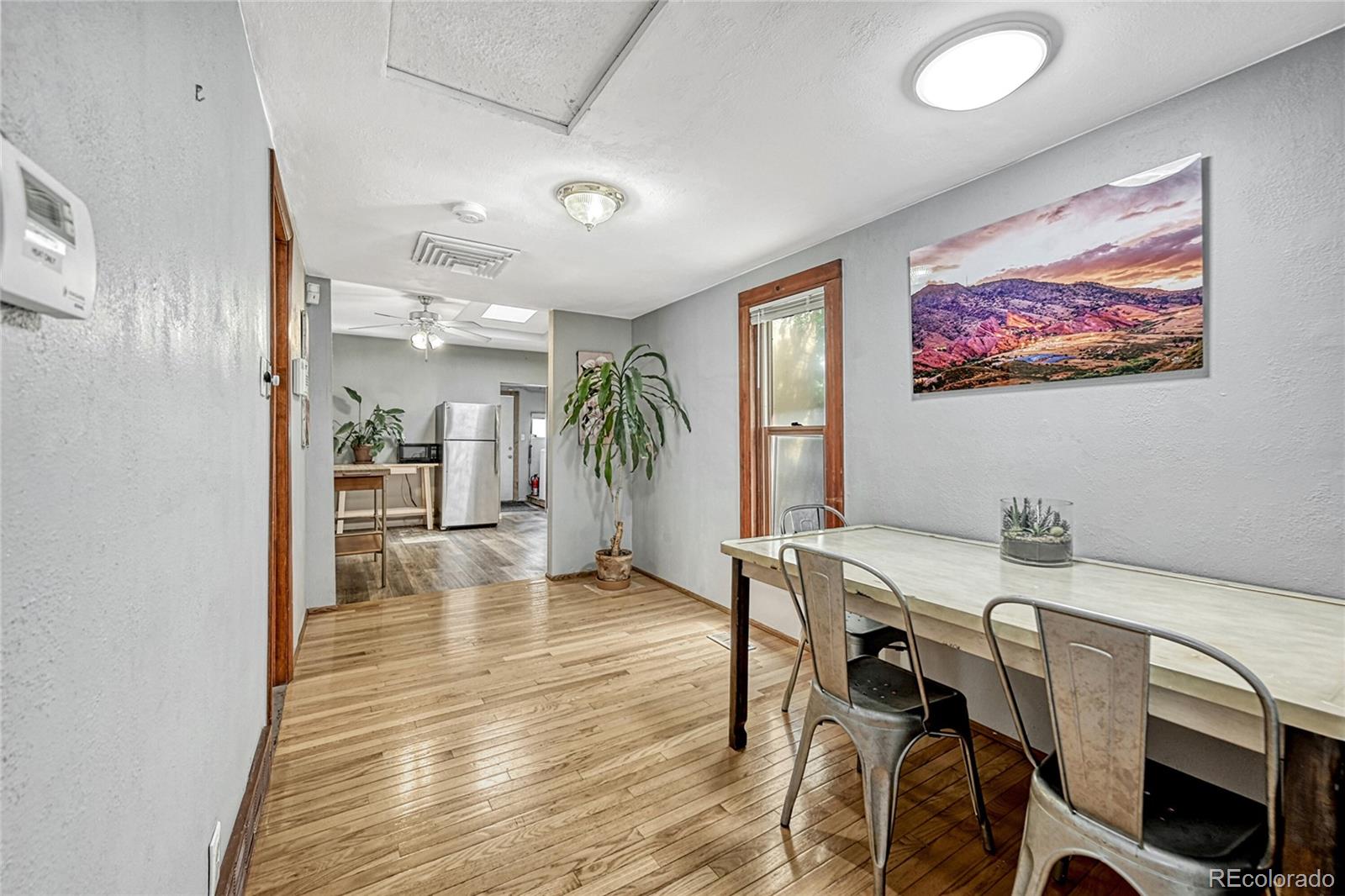 944 Inca Street Denver, CO 80204 - Photo 18 of 29 a view of a dining room with furniture and wooden floor