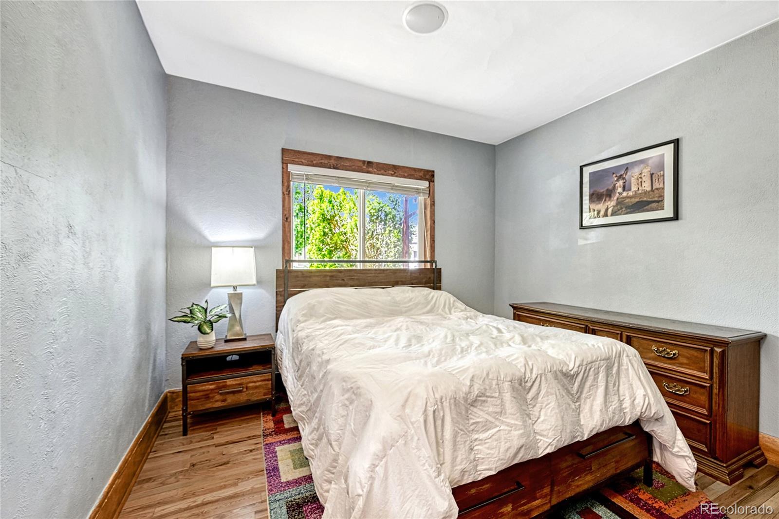 944 Inca Street Denver, CO 80204 - Photo 19 of 29 a bed sitting in a bedroom next to a window