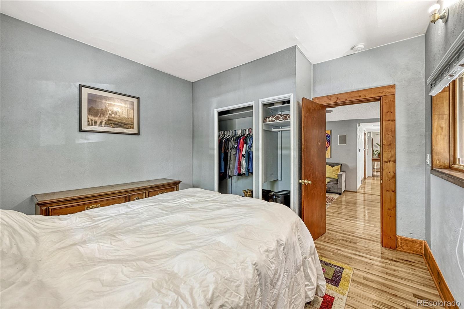944 Inca Street Denver, CO 80204 - Photo 20 of 29 a bed room with a bed and a walk in closet