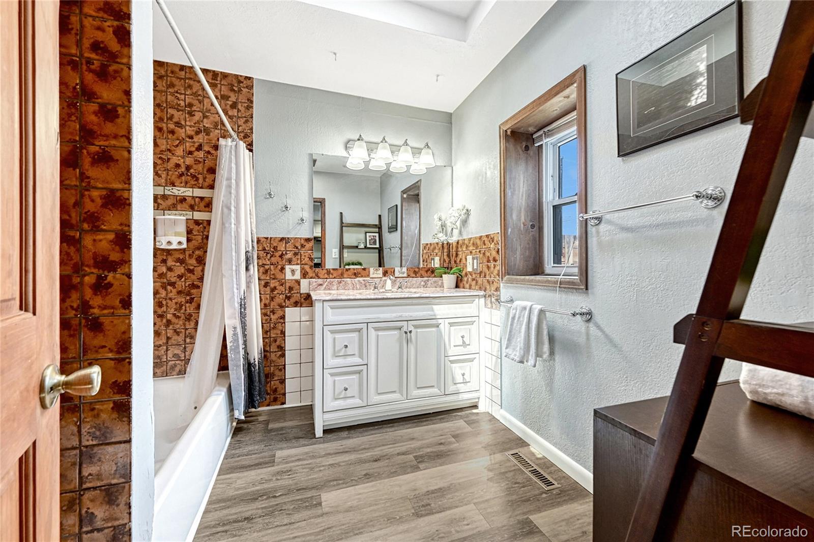 944 Inca Street Denver, CO 80204 - Photo 21 of 29 a bathroom with a double vanity sink and a mirror