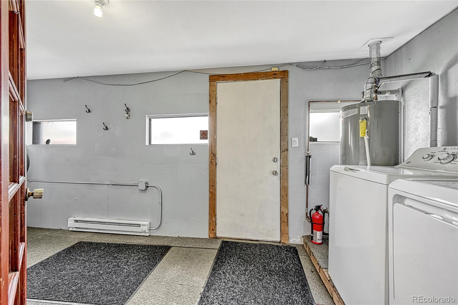 944 Inca Street Denver, CO 80204 - Photo 24 of 29 a bathroom with a granite countertop shower and a toilet
