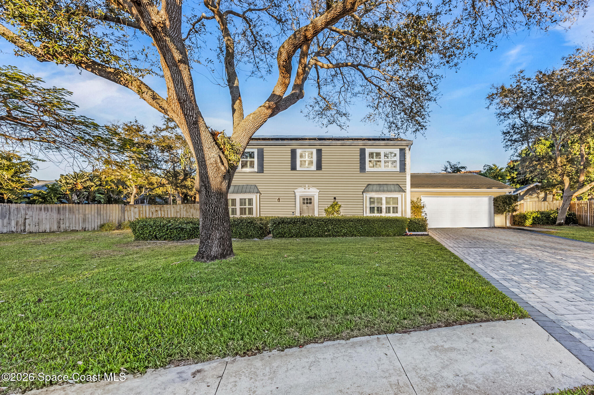 3069 Rio Bonita Street Indialantic, FL 32903 - Photo 1 of 46 a view of a yard in front of a house with large trees