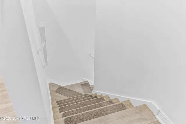 a view of a room with wooden floor and iron swing