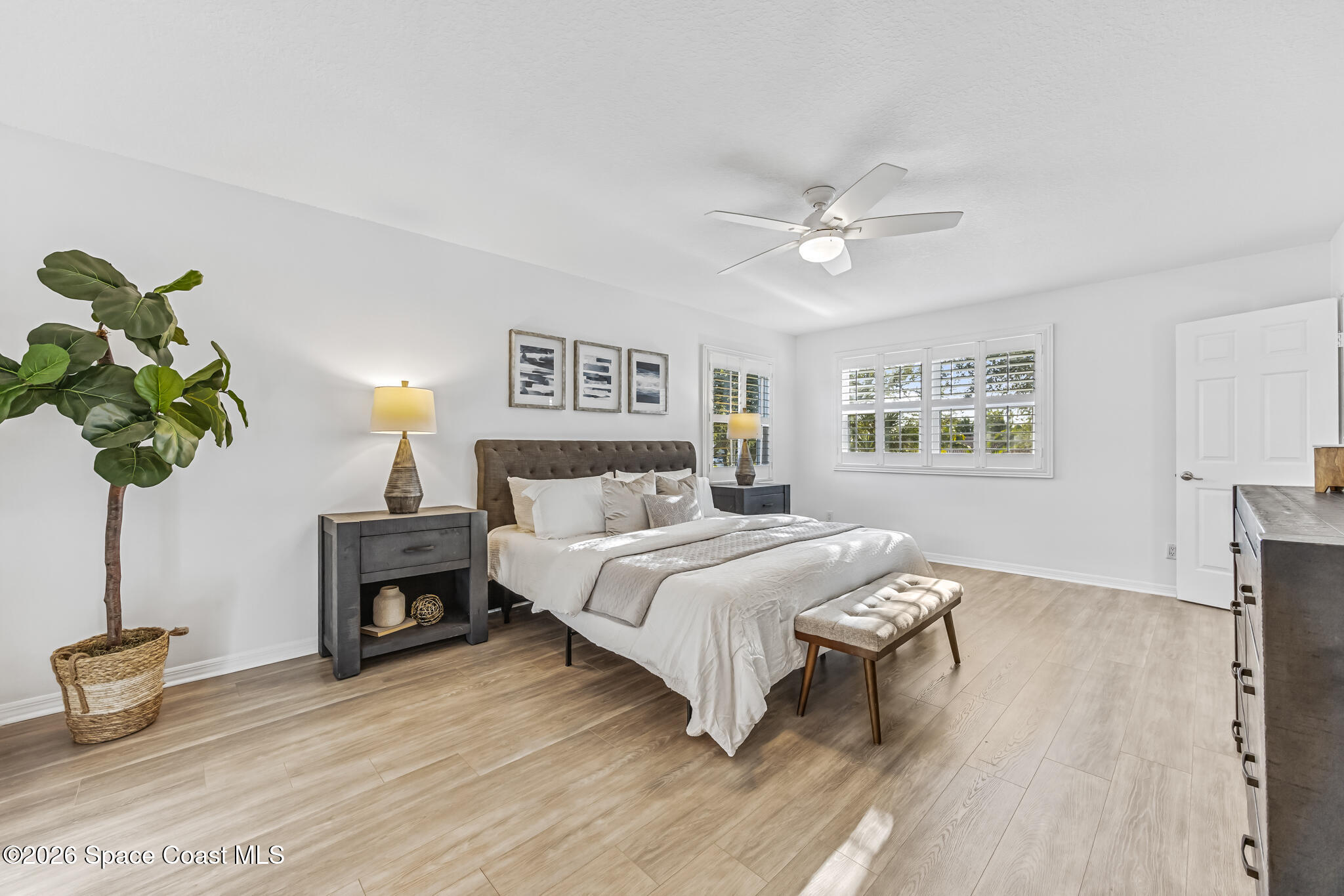 3069 Rio Bonita Street Indialantic, FL 32903 - Photo 26 of 48 a bedroom with a bed furniture and a potted plant