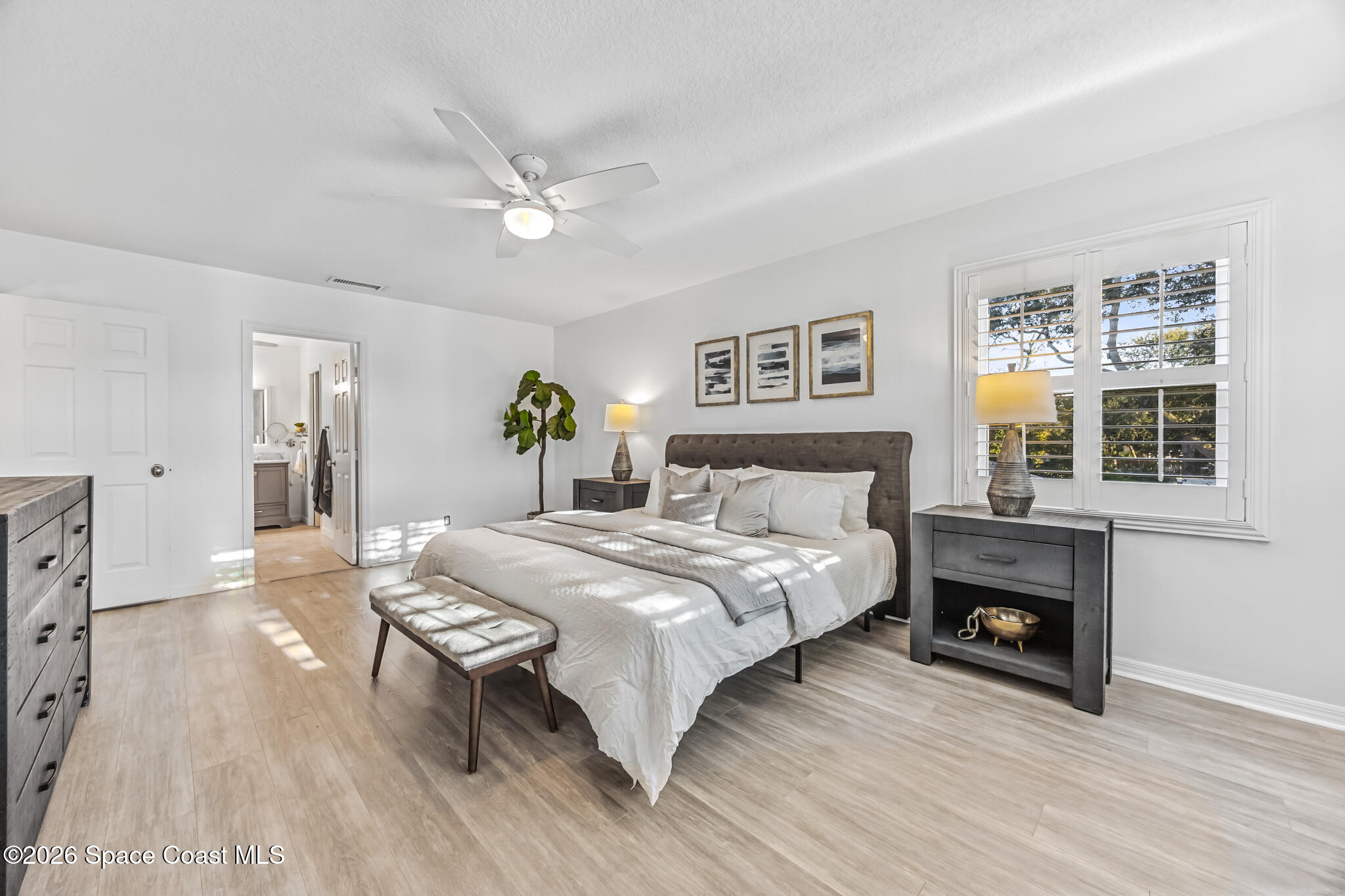 3069 Rio Bonita Street Indialantic, FL 32903 - Photo 27 of 46 a bedroom with a bed and a fireplace