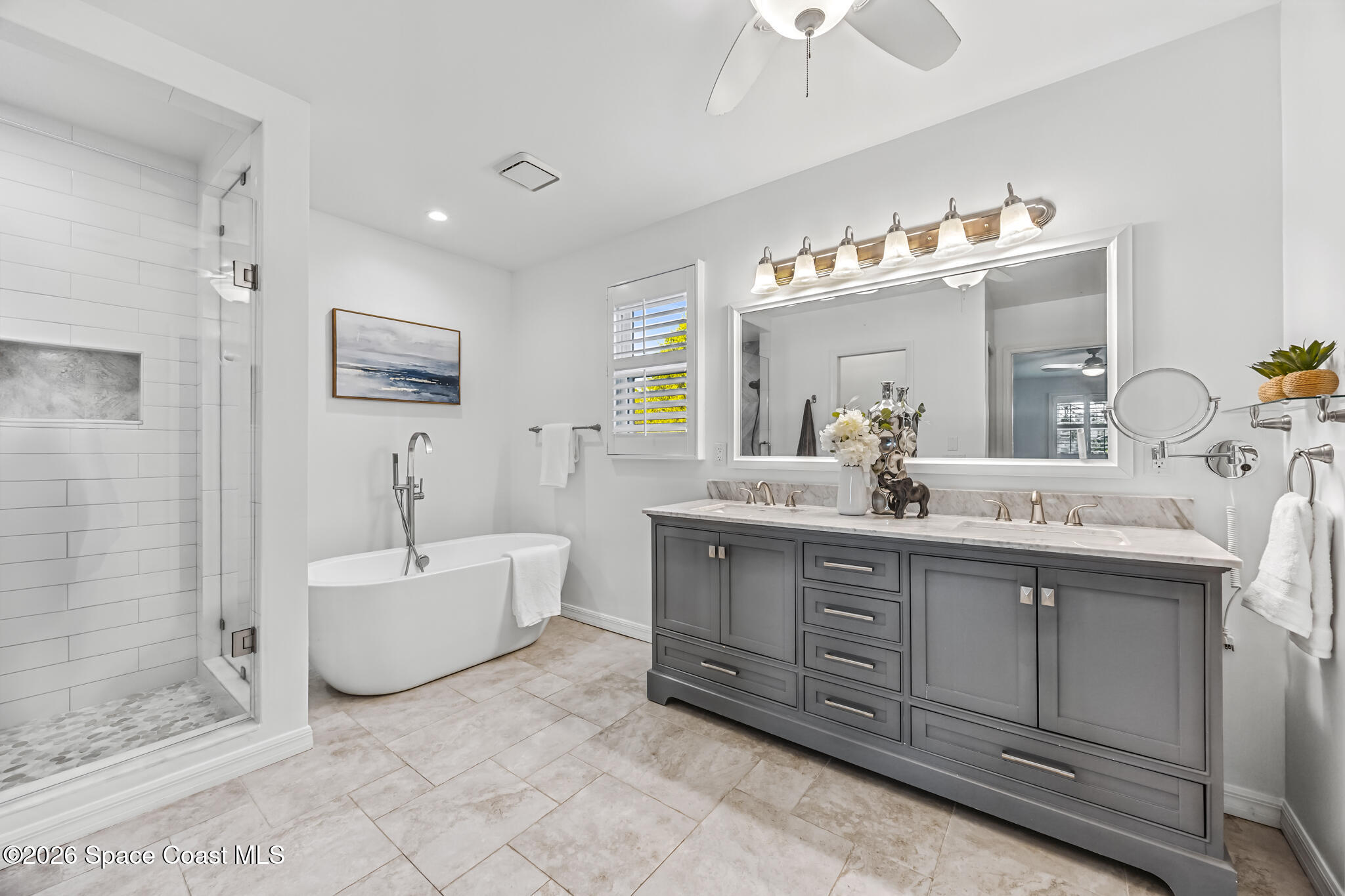 3069 Rio Bonita Street Indialantic, FL 32903 - Photo 30 of 46 a spacious bathroom with a double vanity sink mirror and bathtub