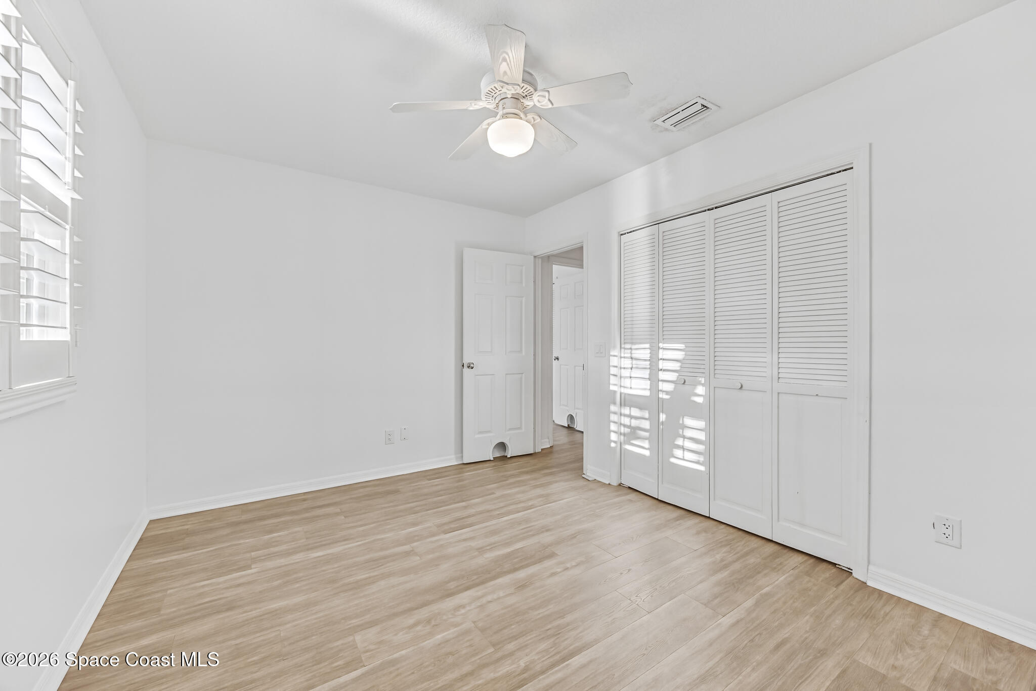 3069 Rio Bonita Street Indialantic, FL 32903 - Photo 32 of 46 wooden floor in an empty room with a window