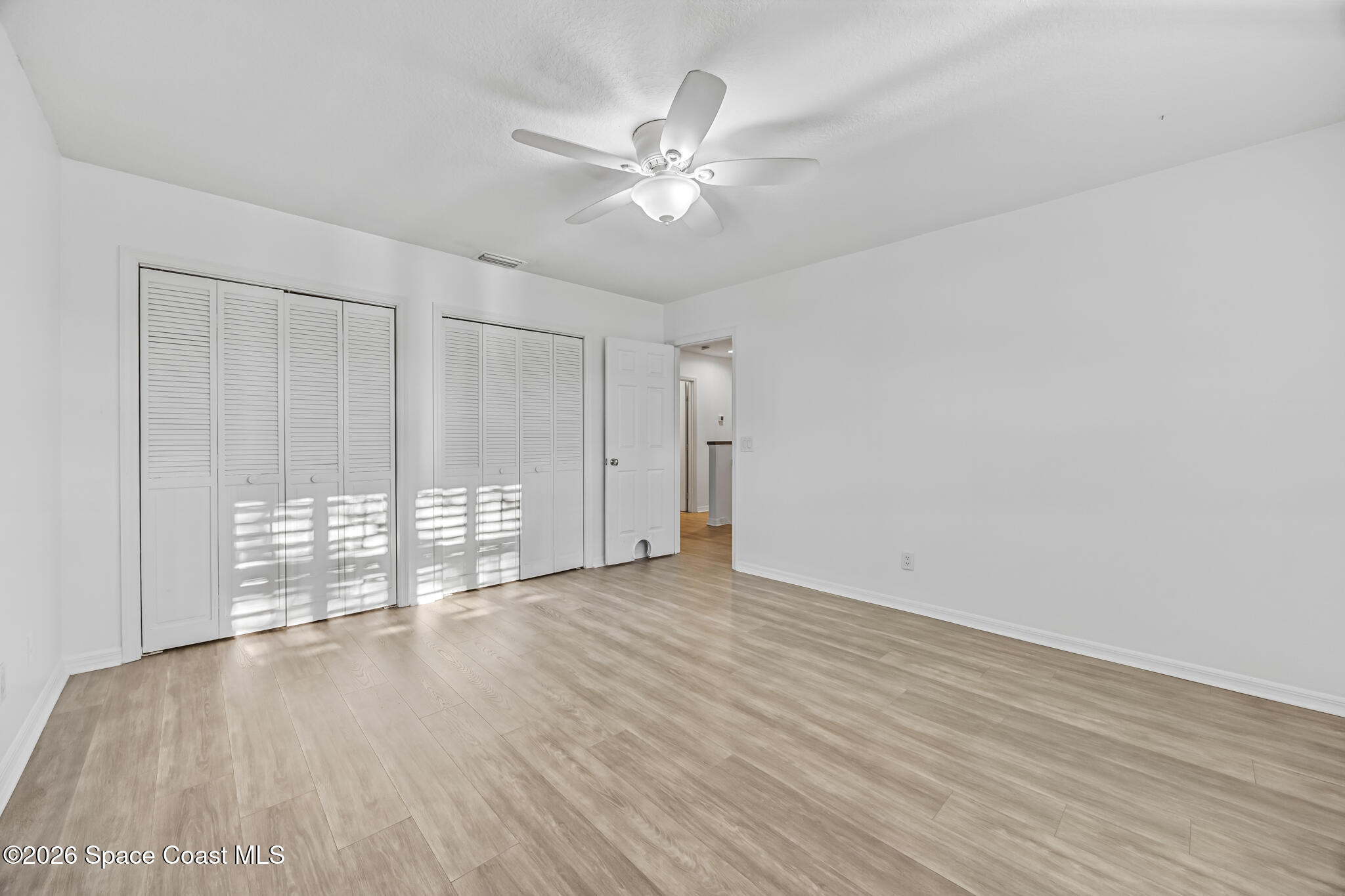3069 Rio Bonita Street Indialantic, FL 32903 - Photo 34 of 46 wooden floor in an empty room with a window