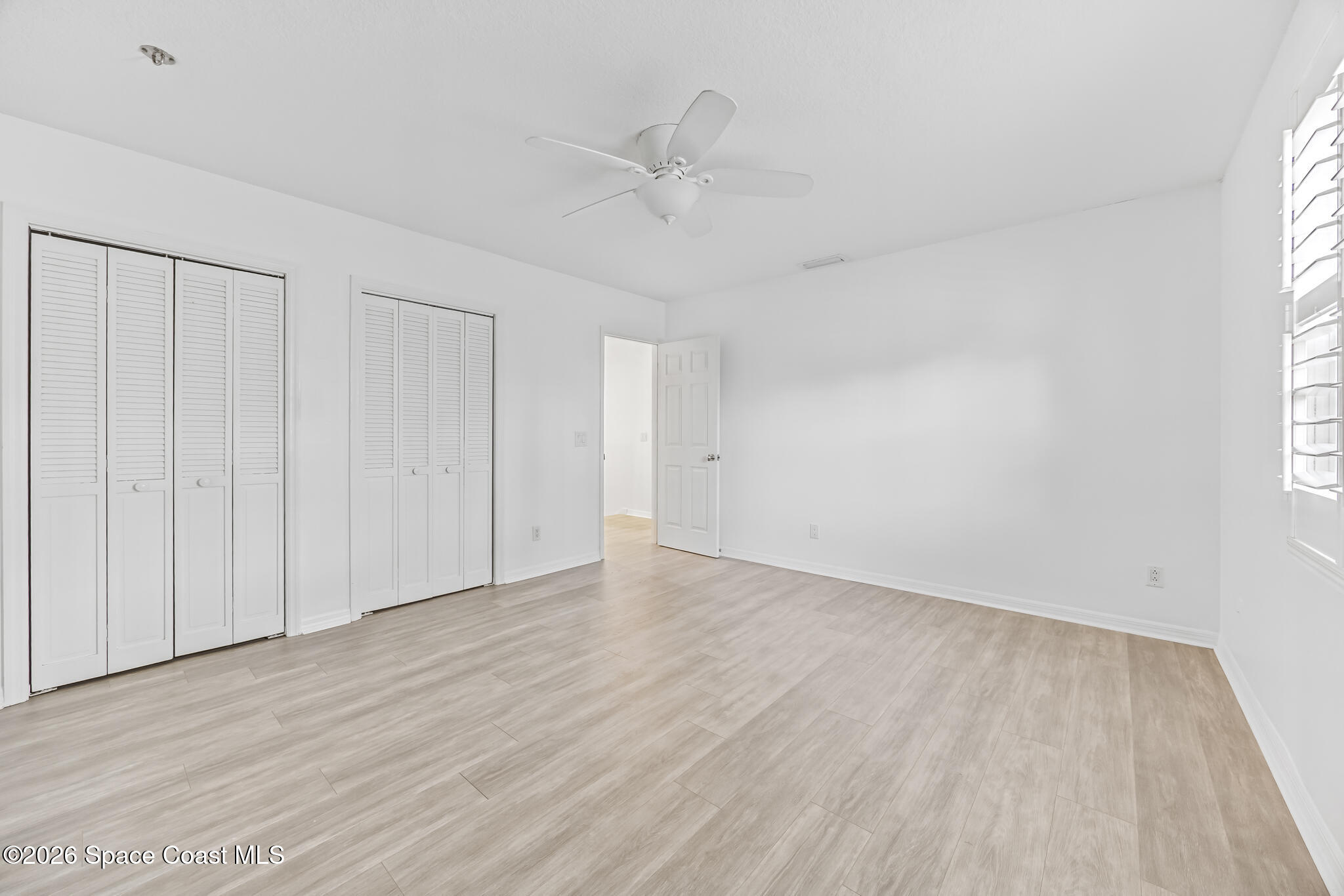 3069 Rio Bonita Street Indialantic, FL 32903 - Photo 38 of 48 a view of an empty room with wooden floor and a window