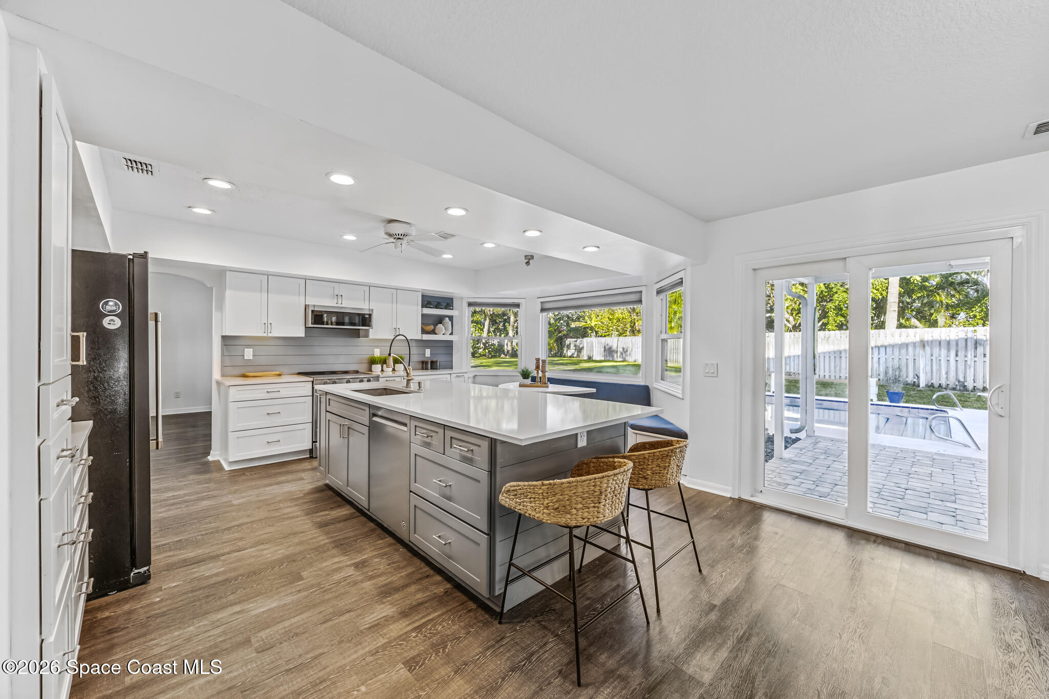 3069 Rio Bonita Street Indialantic, FL 32903 - Photo 5 of 46 a kitchen with stainless steel appliances granite countertop a refrigerator and a stove top oven
