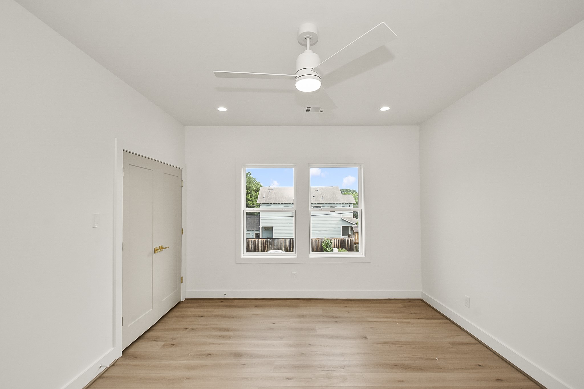 1109 Tabor Street Houston, TX 77009 - Photo 31 of 38 an empty room with wooden floor and windows