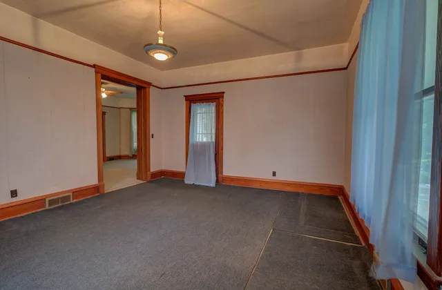 an empty room with a empty space and windows