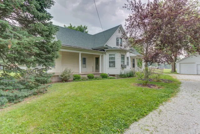 a front view of house with yard and green space