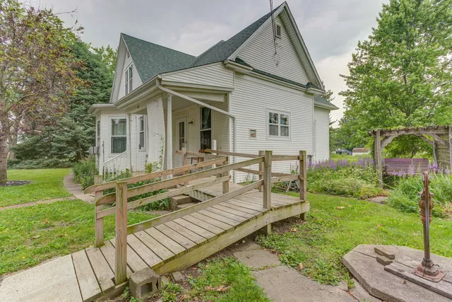 a view of a house with backyard and sitting area