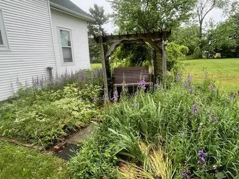 a backyard of a house with table and chairs
