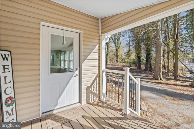a view of a balcony with wooden floor and fence