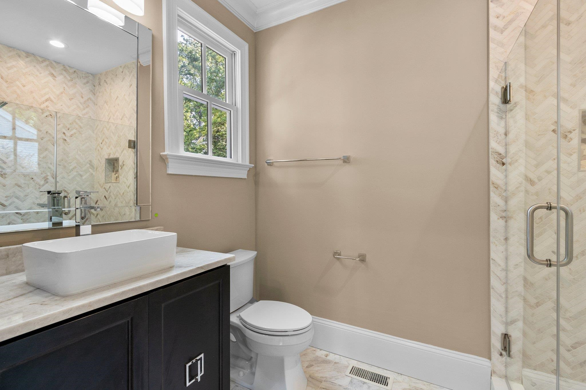 1500 Banbury Road Raleigh, NC 27607 - Photo 33 of 39 Full Bathroom off of Bedroom 4 featuring quartzite countertop and to-the-ceiling shower tiling. Full bathroom