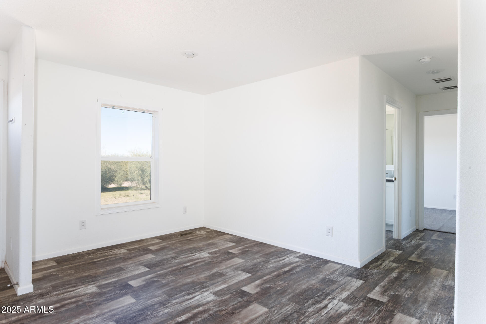 9713 South Thornton Road Casa Grande, AZ 85193 - Photo 12 of 42 an empty room with wooden floor and windows