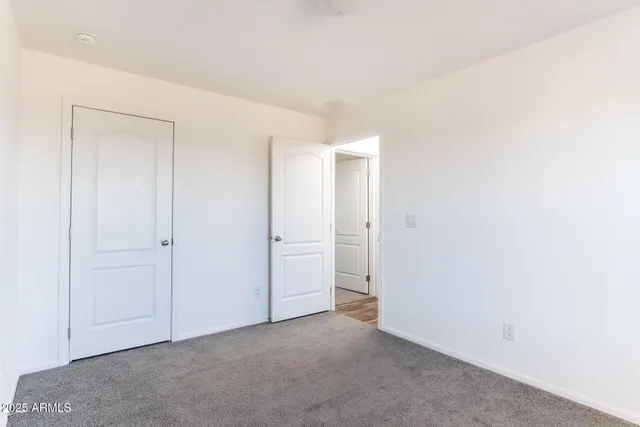 a bathroom with a granite countertop sink a toilet and a window