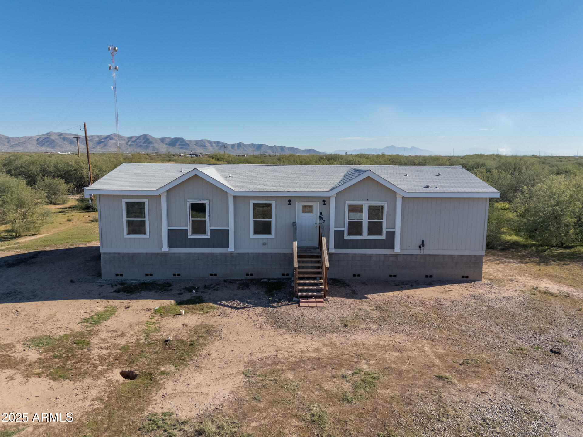 9713 South Thornton Road Casa Grande, AZ 85193 - Photo 27 of 42 a front view of a house with a yard