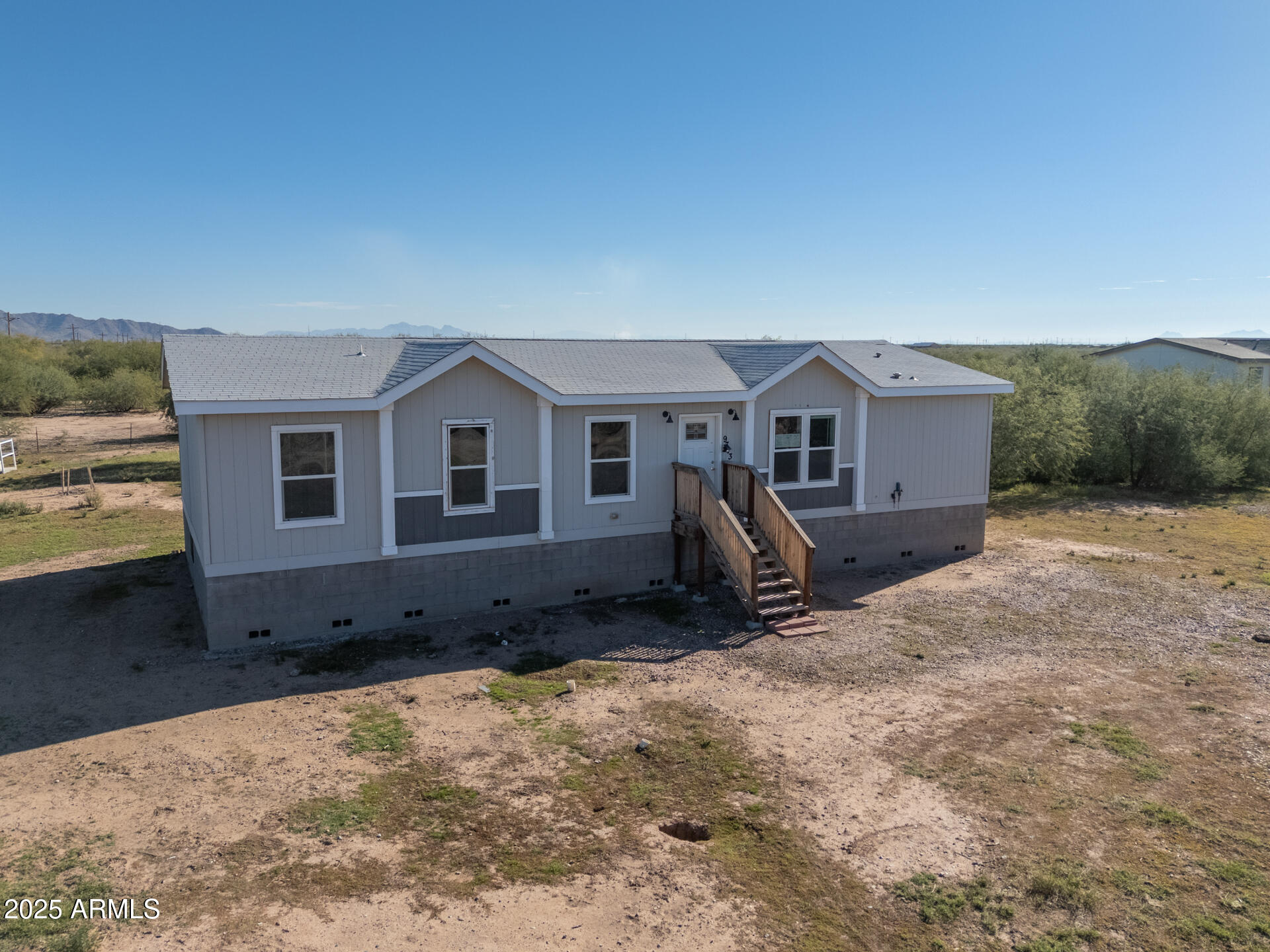9713 South Thornton Road Casa Grande, AZ 85193 - Photo 28 of 42 a front view of a house with a yard and garage