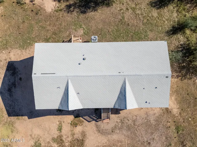 a view of a city of mountains in middle of the road