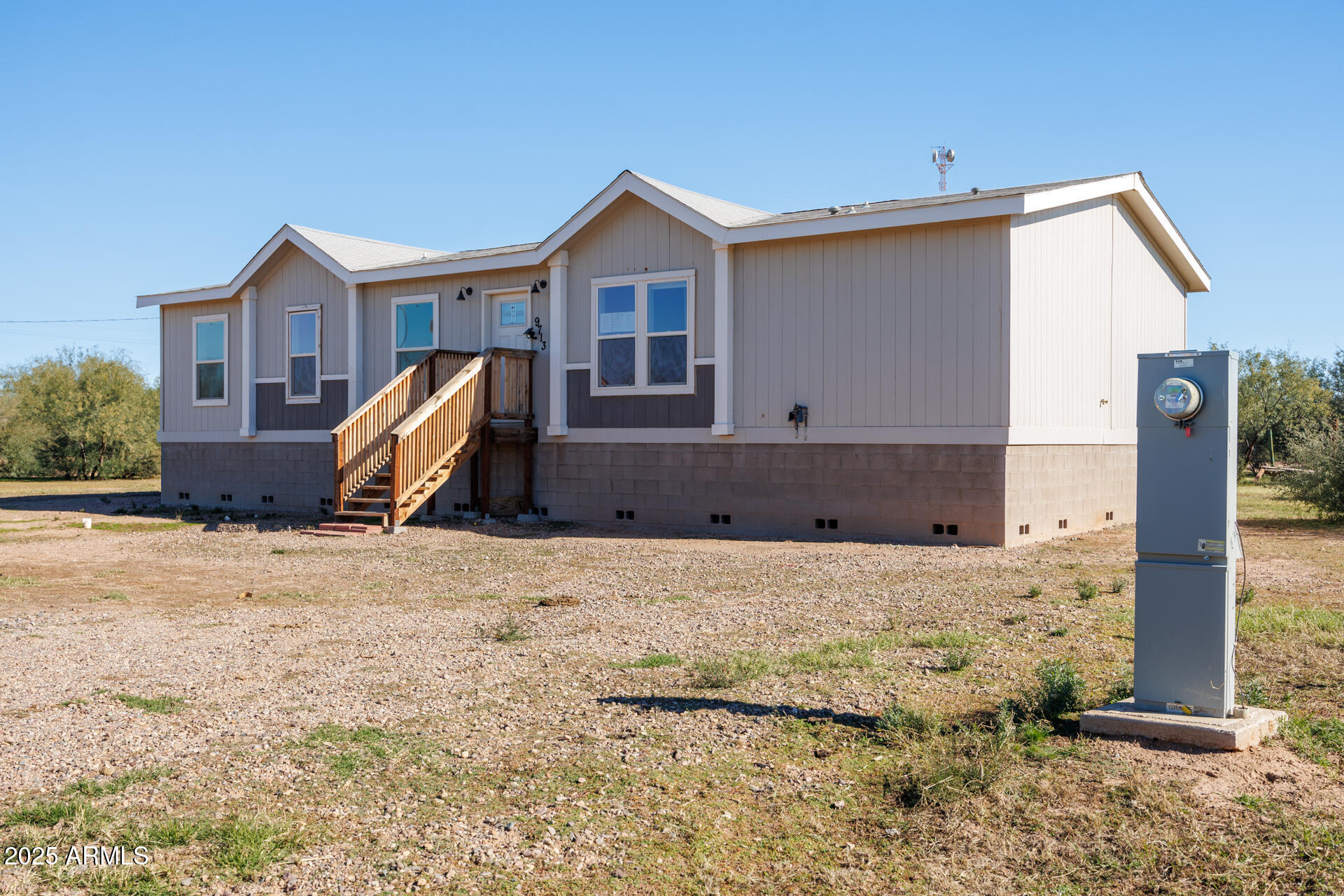 9713 South Thornton Road Casa Grande, AZ 85193 - Photo 4 of 42 a front view of a house with a yard