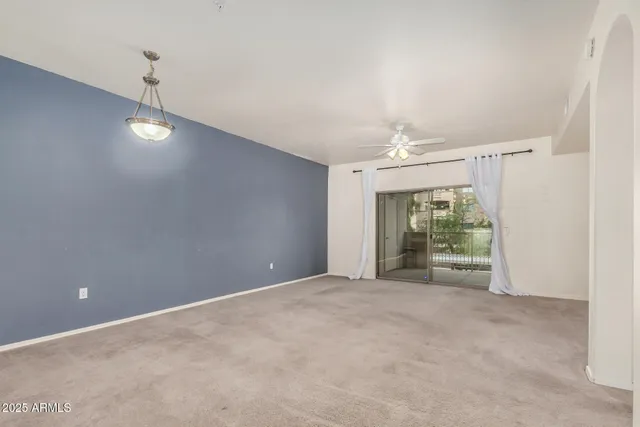 a view of an empty room with a fireplace and a window