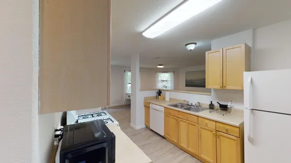a kitchen with a refrigerator and a stove top oven
