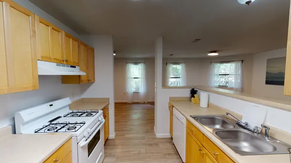 a view of a room with wooden floor and windows