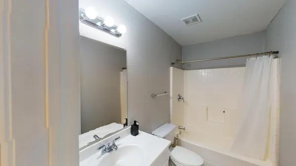 a view of a kitchen with a refrigerator and a sink