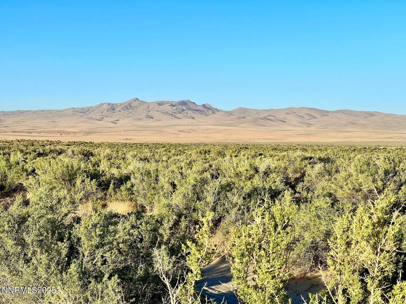 10 Valhalla Road Winnemucca, NV 89445 - Photo 3 of 35 a view of a mountain range with a lush green hillside