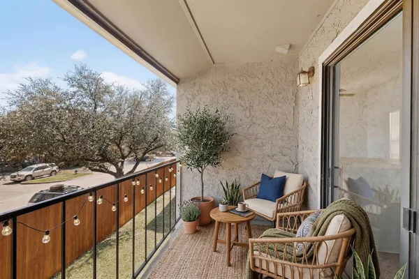 an empty room with windows and cabinet