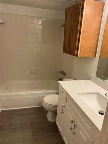 a bathroom with a sink a toilet and a bathtub