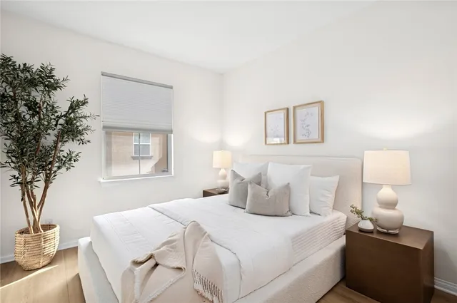 a bedroom with a bed and a night stand