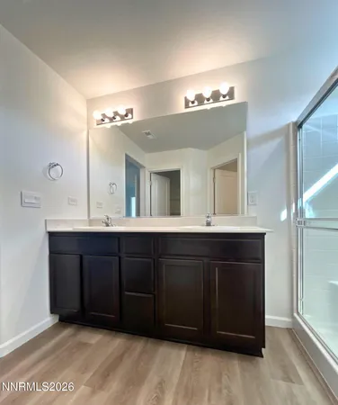 a spacious bathroom with a double vanity sink and a mirror