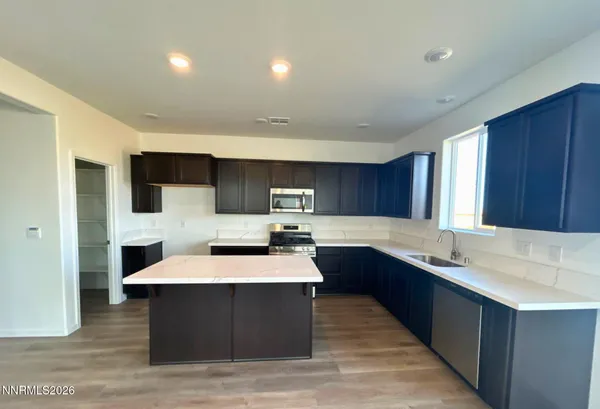 a kitchen with sink cabinets and stainless steel appliances