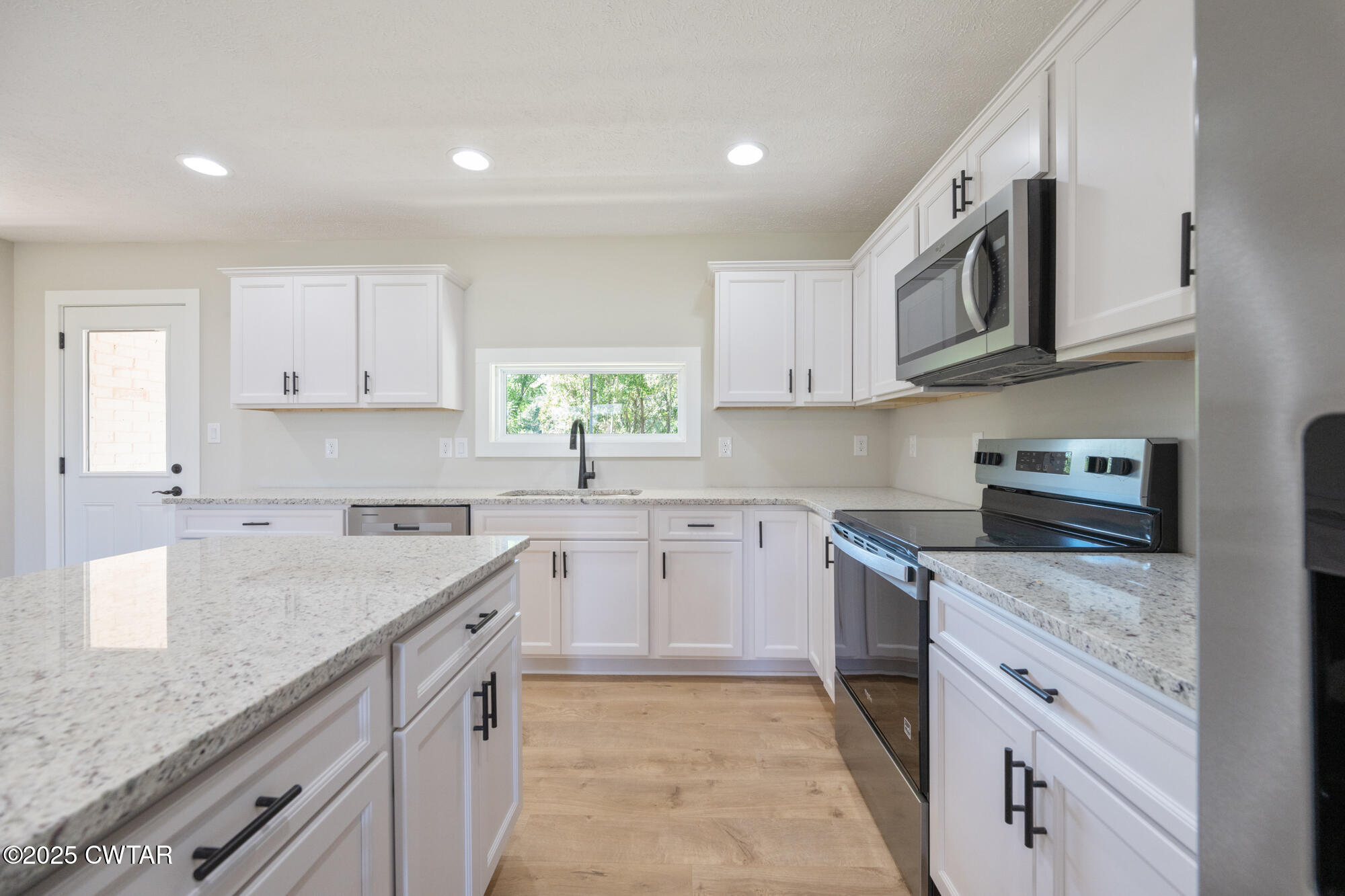 90 Derek Drive Lexington, TN 38351 - Photo 13 of 32 a kitchen with granite countertop cabinets stainless steel appliances and a sink