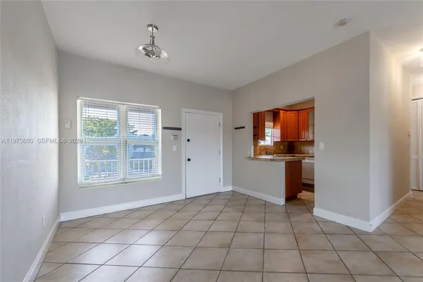 a kitchen with a refrigerator a sink and cabinets