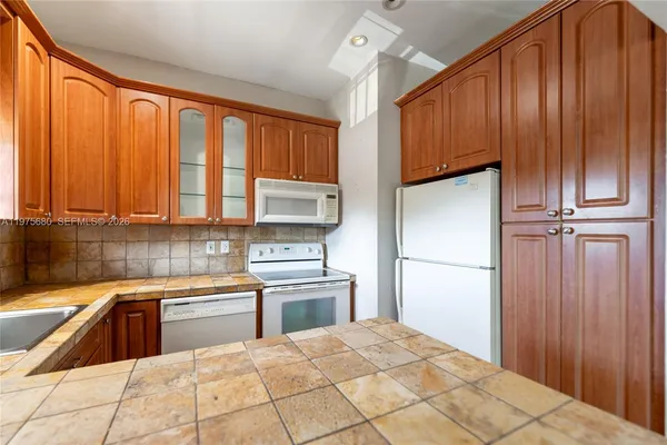 a kitchen with a stove a sink and a refrigerator