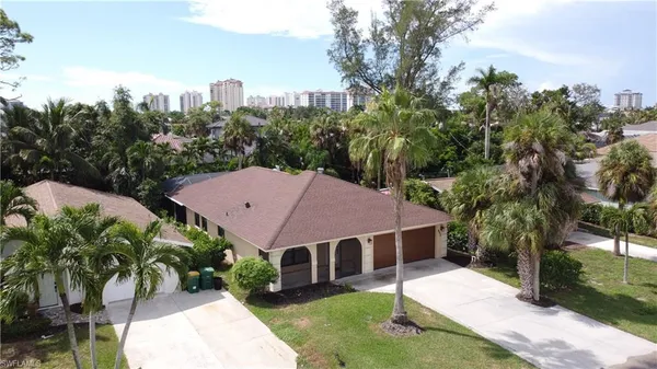a aerial view of a house with a yard and potted plants