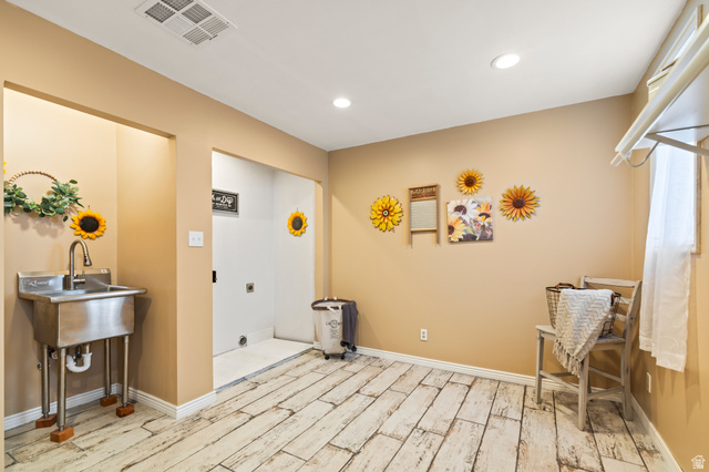 460 Omni Point Road Central Valley, UT 84754 - Photo 55 of 101 Utility room featuring wood-finish flooring, recessed lighting, and a stainless steel utility sink with a high-arc faucet