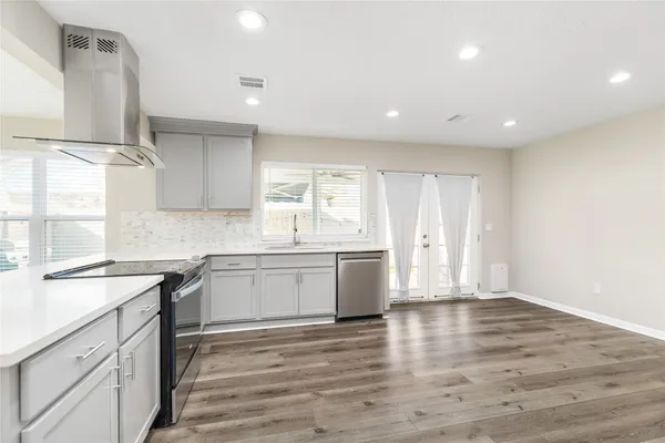 a kitchen with granite countertop white cabinets and white appliances