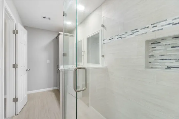 a bathroom with double sink and a mirror