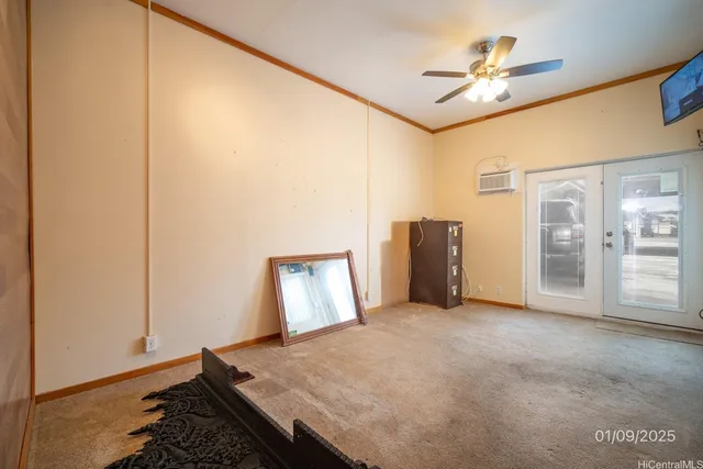 a view of a livingroom with wooden floor and a ceiling fan